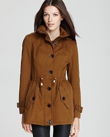 Melding fashion with function, a cotton Burberry Brit anorak features bullish buckle cuffs and a packable hood for utilitarian chic.