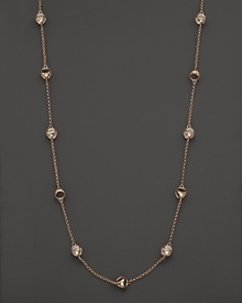 Clear rock crystal rests inside 18K rose gold stations on this modern Di MODOLO necklace.