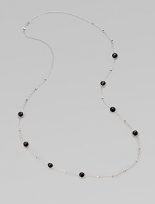 A long sterling silver chain with hammered bead and faceted onyx stations.Onyx Sterling silver Length, about 38 Lobster clasp closure Imported 