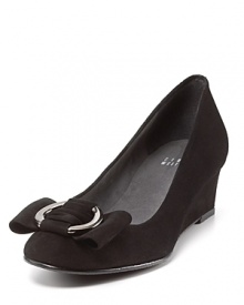 Demure demi-wedge pumps flaunt silver buckle bows, evoking a sense of ladylike chic. By Stuart Weitzman.