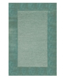 A looped center of mottled tones is framed by rich color in tufted pile, presenting a modern area rug that is both casual and practical. Hand tufted in India of pure wool fibers, the Madrid area rug is a comforting, stylish addition to any decor.