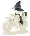 A wickedly cute witch rides west with Toto in tow, pedaling through the land of Oz in this porcelain bisque Snowbabies figurine from Department 56.