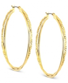 Anne Klein puts its own twist on a classic. This pair of hoop earrings is crafted from gold-tone mixed metal, and features a shapely and stylish look. Approximate diameter: 1 inch.