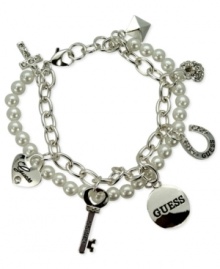 GUESS doubles the style factor with this two-row charm bracelet. Crafted from silver-tone mixed metal, the bracelet pops with glass pearls and crystal accents. Item comes packaged in a signature GUESS Gift Box. Approximate length: 7-1/2 inches long. Approximate diameter: 1-1/2 inches. Approximate drop: 1/2 inch.