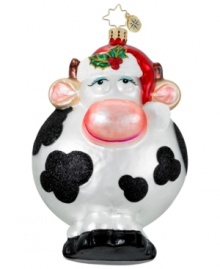 A whimsical cow gets a festive makeover complete with a Santa hat and holly embellishment. Hand-painted glass ornament from Christopher Radko.