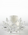 A fanciful crystal Lotus blossom from Lighting by Design brightens with the soft glow of candlelight for truly beautiful, over-the-top shine. Includes pillar candle.