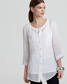 White linen crafts an airy silhouette for a relaxed take on the classic button down. Pair the breezy Eileen Fisher tunic with graphic shorts for a night out or crisp denim for everyday ease.