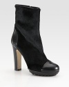 Elaborate calf hair and leather style with an exposed side zipper and rubber sole for extra traction. Stacked heel, 4 (100mm)Covered platform, 1½ (40mm)Compares to a 2½ heel (65mm)Calf hair and leather upperSide zipperGenuine dyed lamb fur liningRubber and leather solePadded insoleMade in Italy