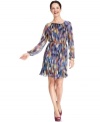 Jessica Howard's dress is outfitted with a colorful print that's softly blurred and a silhouette that's fully pleated!