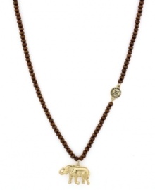 An elephant always brings good luck. BCBGeneration's Eastern-inspired pendant features a gold tone mixed metal charm and charm accents strung from a wood bead chain. Approximate length: 24 inches. Approximate drop: 1 inch.