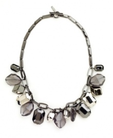 Freshen your look for fall with style that makes an impact. Nine West's shimmery collar necklace features plastic beads in various metallic shades. Crafted in silver and hematite tone mixed metal. Approximate length: 16 inches. Approximate drop: 1 inch.