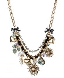 Turn on the charm with this funky frontal necklace from Betsey Johnson. Fabulously flaunts gold tone flowers with crystal accents and glass pearls, blue lightning bugs with crystal accents, gold tone bubble hearts, gold tone leaves with blue-colored crystal accents, blue faceted beads, glass pearls and hematite plated bows with crystal accents. Crafted in gold tone mixed metal intertwined with black grosgrain ribbon and crystal cup chain accents. Approximate length: 16 inches + 3-inch extender. Approximate drop: 2 inches.