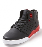 A lean, mid-top sneaker rendered in full-grain leather with bold color block accents and engineered side panels.