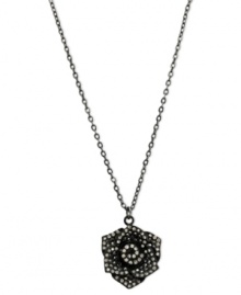 Petals to the metal. This necklace from GUESS is crafted from sprayed-jet mixed metal, with a flower pendant crafted from hematite-tone mixed metal and glass crystals adding luster. Item comes packaged in a signature GUESS Gift Box. Approximate length: 16 inches + 2-inch extender. Approximate drop: 1-1/2 inches.