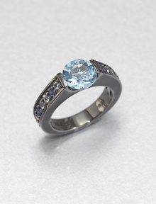 A simple, square-edged band is channel-set with an icy cool mix of blue sapphire, white topaz and blue topaz stones, creating an elegant showcase for a faceted pastel blue topaz.Sapphires, white topaz and blue topazBlack rhodium-plated sterling silverWidth, about .7Imported