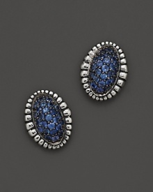 A fluted edge in sterling silver frames sparkling blue sapphires. From Lagos.