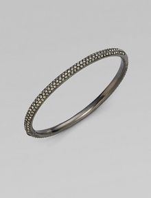 EXCLUSIVELY AT SAKS. Double rows of radiant crystals with a subtle dark cast are hand-set within an antiqued hinged bangle. Crystal Antiqued silvertone Diameter, about 2¼ Push-lock clasp Imported