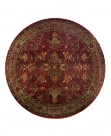 A truly charming interpretation of a traditional carpet, this round rug features a center medallion ringed by palmettes and floral details in sage green, topaz and slate blue against a rich burgundy ground. Striated effects create the weathered look of handmade rugs in a stain-resistant, no-shed manmade fiber.