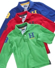 The polo shirt is in play: Tommy Hilfiger updates the classic with a capital H graphic, long sleeves, and a number patch, and winds up with a style that will carry any boy straight through the school year.