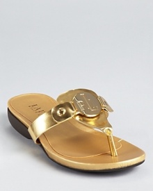 A monogrammed badge showcases Lauren Ralph Lauren's recognizable initials on these gleaming metallic sandals, equipped with a low, practical wedge.