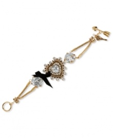 A little heart goes a long way. This darling toggle bracelet from Betsey Johnson boasts a heart charm with crystal accents and large crystal stones with a black grosgrain ribbon bow. Crafted in antiqued gold tone mixed metal. Approximate length: 7-1/2 inches long. Approximate width: 1-1/2 inches.