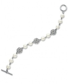 The name says it all...the High Society bracelet from Lauren by Ralph Lauren stands in a class all its own. Pretty glass pearls (8 mm) combine with glass-accented basket weave charms for a look that spells luxury. Setting and toggle clasp crafted in silver tone mixed metal. Approximate length: 7-1/2 inches.