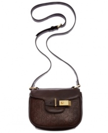 Add some signature styling to your purse portfolio with this logo-embossed leather bag from Clavin Klein. The causal crossbody design is outfitted with subtle, golden hardware, while plenty of interior pockets keep you organized on-the-go.