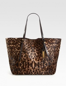 A chic haircalf style in an exotic animal print accented with smooth leather trim.Double adjustable leather top handles, 8¾-9½ dropMagnetic snap closureOne inside zip pocketTwo inside open pocketsSuede lining14W X 12H X 7DImported