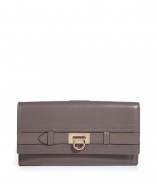 Elegant wallet in supple taupe leather - A standout, ladylike luxe accessory from Salvatore Ferragamo - Classic style, smart design - Oblong envelope shape with flap - Interior zip pocket,  room for coins, bills and credit cards - Chic hardware logo detail - Timeless and sophisticated, great as a gift for you or someone else