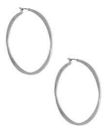 A classic hoop silhouette will never let you down. Nine West's sleek earrings finish off your everyday look. Finished with a click closure. Crafted from imitation rhodium tone mixed metal. Approximate diameter: 2 inches.