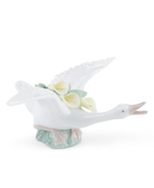 Spreading its wings with yellow calla lilies in tow, this elegant duck is poised to take flight in lustrous Lladro porcelain.