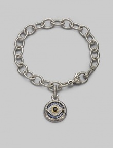 Bold, textured links of sterling silver hold a protective evil eye charm, radiantly created of white, blue and black sapphires with a touch of 18k gold. Sapphires Sterling silver and 18k yellow gold Bracelet length, about 7½ Charm diameter, about ¾ Heart-shaped lobster clasp Made in USA