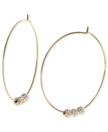 Michael Kors adds an elegant touch to its pair of hoop earrings. Crafted from gold ion-plated mixed metal, the earrings feature glass pave fireballs for a lustrous touch. Approximate diameter: 2 inches.