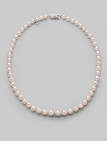 A classic strand of graduated white Akoya pearls with a pretty filigree clasp. 7mm- 9mm white round cultured pearls Quality: A1 18k white gold Length, about 18 Mikimoto signature clasp Imported