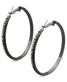 Luminous details take charge on these clutchless hoops from GUESS. Clear, amethyst and light amethyst crystal stones adorn a classic earring silhouette. Crafted in hematite tone mixed metal. Approximate drop: 2-1/4 inches.