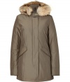 Stylish and sporty grey down coat in a washable cotton blend from the American heritage label Woolrich - Tapers slightly at waist, hits at mid-thigh - Rabbit fur collar lends this coat a veritable feeling of warmth and luxe - Water and snow resistant, with multiple pockets and hood - Exceptionally warm, can be worn in temperatures as low as -30 F - A versatile, classically elegant coat that can be worn for life - Perfect for both city streets and country slopes