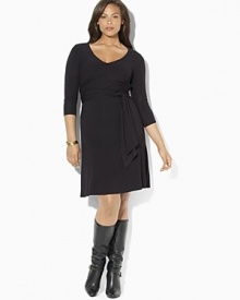 A sleek jersey dress is crafted in a figure-flattering wrap silhouette and finished with chic three-quarter-length sleeves.