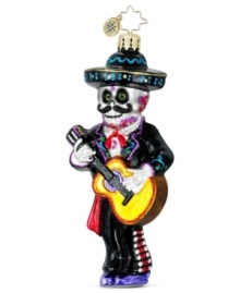 A decked-out skeleton strums the guitar in Christopher Radko's handcrafted ornament celebrating the Day of the Dead.