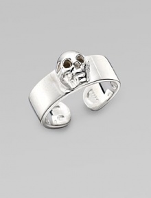 A thick adjustable band with a single prominent skull at the center. Sterling silver Width, about ¾ Made in Italy 