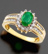 A ring fit for royalty. Stunning oval-cut emerald (3/4 ct. t.w.) is surrounded by sparkling diamonds (3/8 ct. t.w.) crafted in 14k gold.