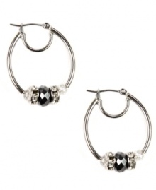 Sophisticated in silver. Nine West's darling hoop style showcases tonal plastic beads and rondelles embellished with crystal stones. Crafted in imitation rhodium-plated mixed metal. Approximate drop: 1-1/4 inches. Approximate diameter: 1 inch.