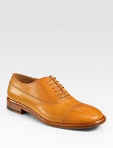 An extraordinary oxford design gets a modern update, rendered in a smooth, vibrant leather with stitching and captoe detail.Leather upperLeather liningPadded insoleLeather soleMade in Italy