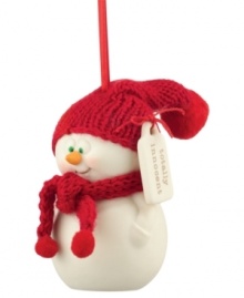 Big green eyes stare out with childlike wonder from this oh-so-innocent snowman ornament. A red knit scarf and hat contrast smooth porcelain bisque from Department 56.