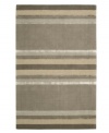 Linear designs are accented with exotic faux silk to create a timeless palette in the Sahara area rug from Calvin Klein. Crafted by skilled artisans in India, it features generously thick wool and viscose fibers woven to create remarkable strength and impeccable elegance.