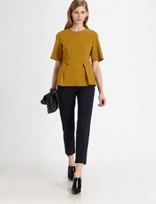 Pure vintage vibes-- this pleated peplum top has elbow-length sleeves and a touch of stretch. CrewneckElbow-length sleevesHook-and-eye closurePeplum hemInvisible back zipper58% viscose/39% wool/3% elastaneDry cleanImportedModel shown is 5'10 (177cm) wearing US size 2.