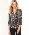 Me-owww! INC's jersey top looks wildly chic in a seductive leopard-print. Rhinestone buttons give this top extra shine.