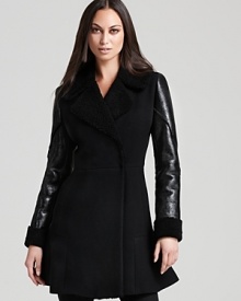 A striking play on texture, a sumptuous shearling DKNY coat is offset by sleek sleeves for real modern edge.