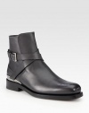 A classic chelsea boot style receives a downtown edge, constructed from fine Italian leather with wrap buckle detail and metal inserts on the heel and sole.Leather upperLeather liningPadded insoleLeather soleMade in Italy