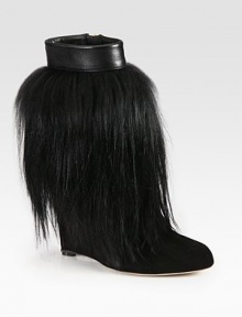 Luxe goat hair covers this suede silhouette topped with leather trim for a look dripping with edgy style. Self-covered wedge, 4¼ (110mm)Goat hair and suede upper with leather trimSide zipLeather lining and solePadded insoleMade in Italy