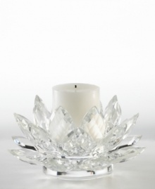 A fanciful crystal Lotus blossom from Lighting by Design brightens with the soft glow of candlelight for truly beautiful, over-the-top shine. Includes pillar candle.